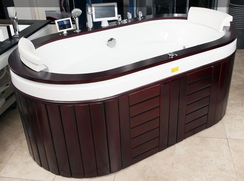 Example image of Hydra Freestanding Whirlpool Bath With Oak Surround. 1930x1080.